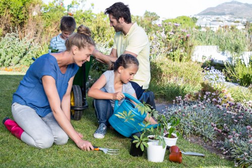 Gardener performing summer maintenance tasks
