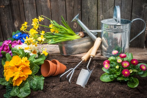 Accessibility icon next to gardening tools symbolizing accessible grounds care services.
