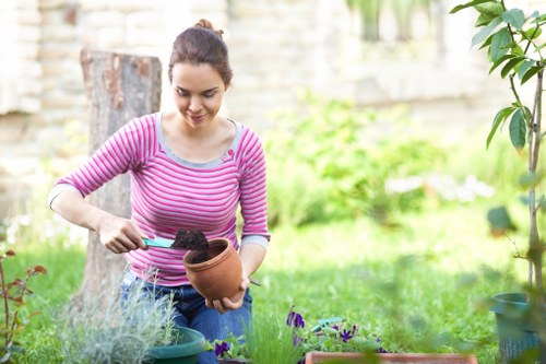 Team member sorting garden waste at a Teddington property